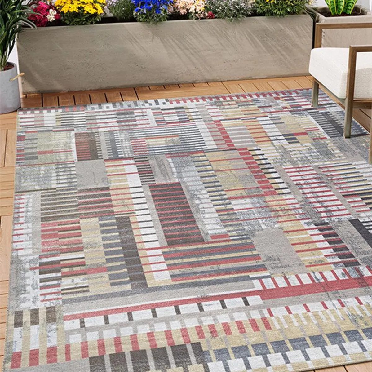 Multicolour abstract rectangular carpet placed in an outdoor-style seating setting