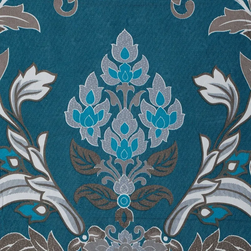 Close-up of the ornate ethnic floral motif on the blue bedsheet