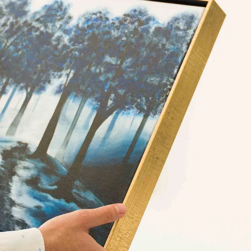 Close-up of the side profile of a framed canvas held in hand