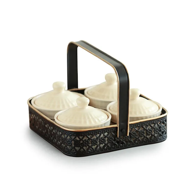 Five-piece ivory and black ceramic jar set with four lidded jars in a holder.