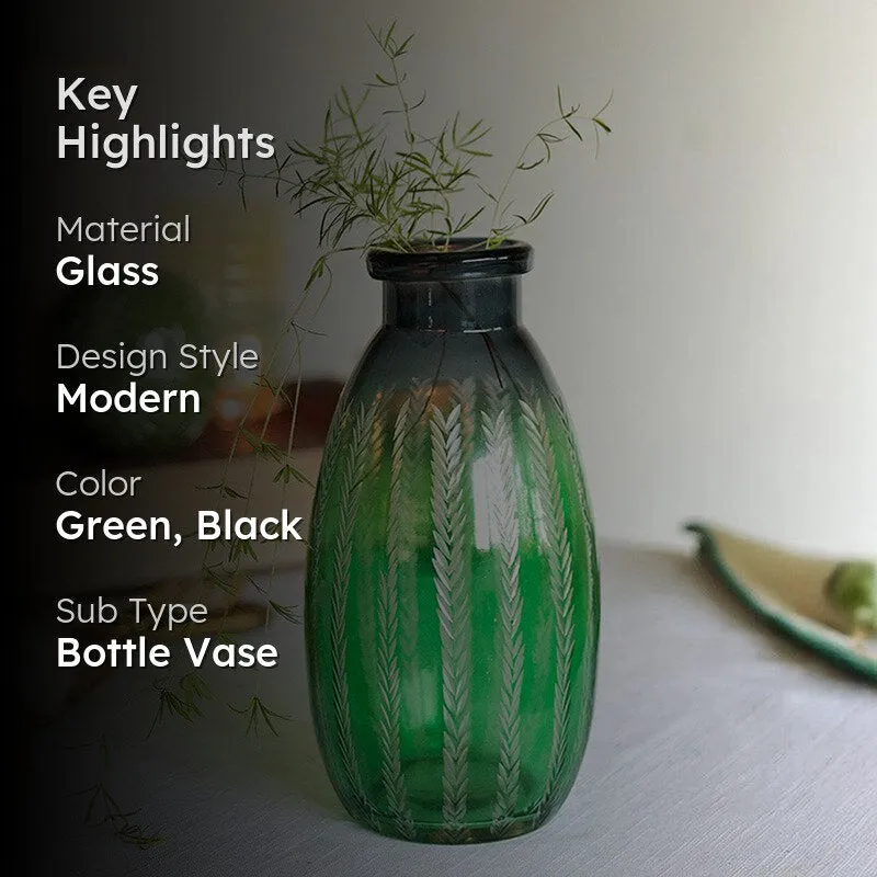 Green glass bottle vase with etched leaf pattern and dark neck