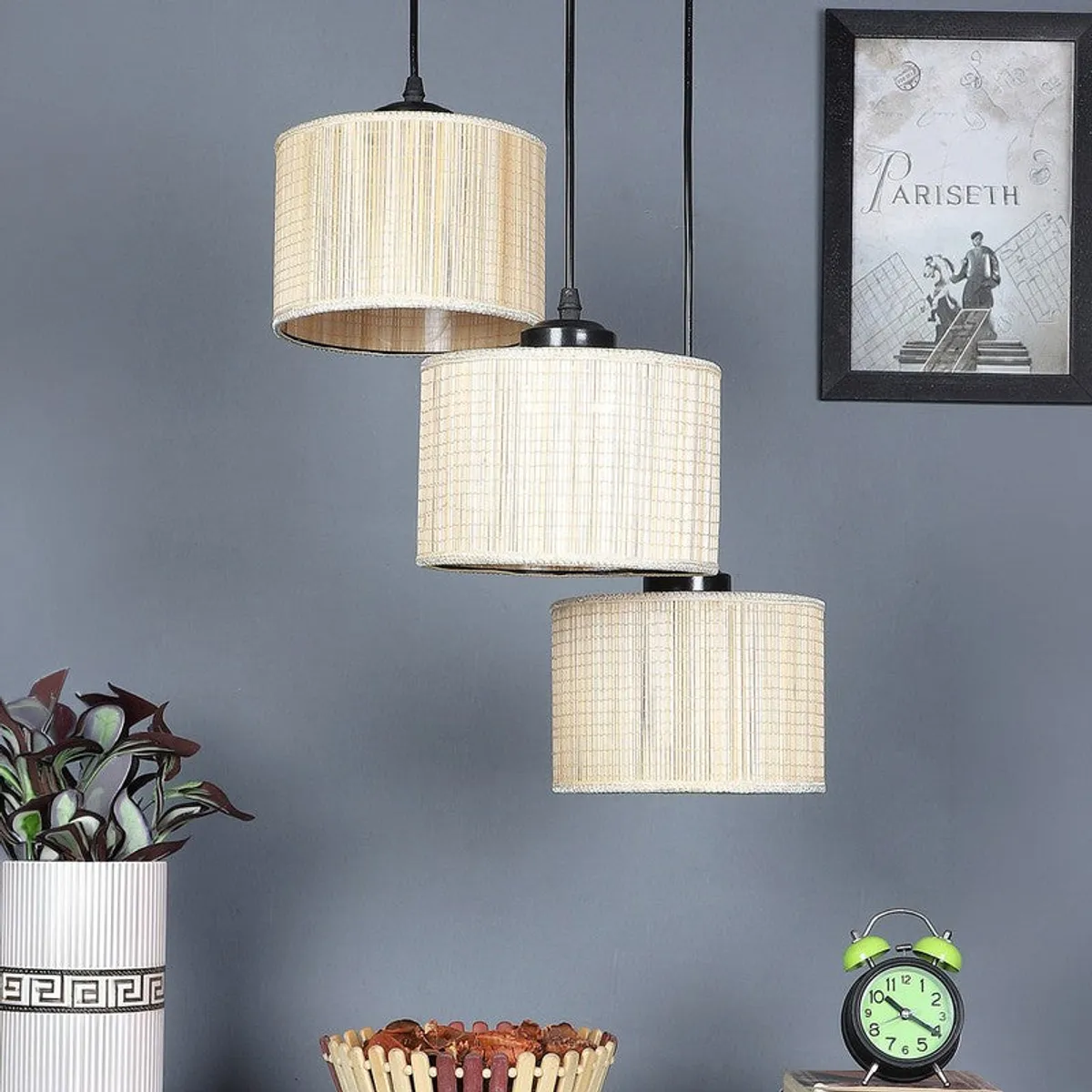 Three-light beige ceiling lamp with cylindrical shades in a styled room