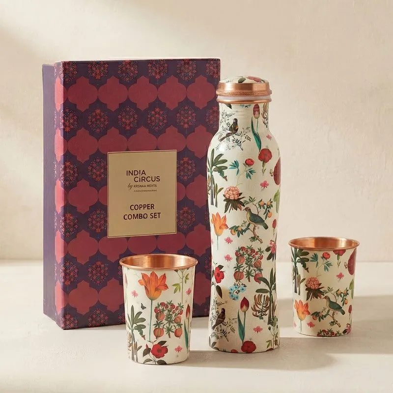 Floral copper bottle and two tumblers displayed beside a patterned presentation box