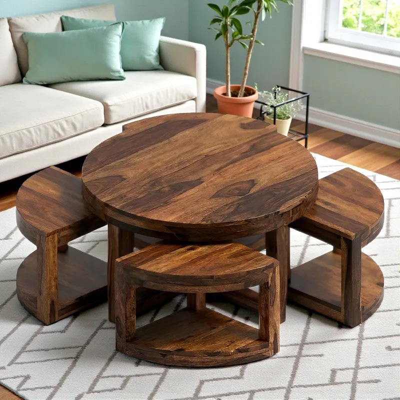 Round brown wooden center table with four matching stools in a living room setting