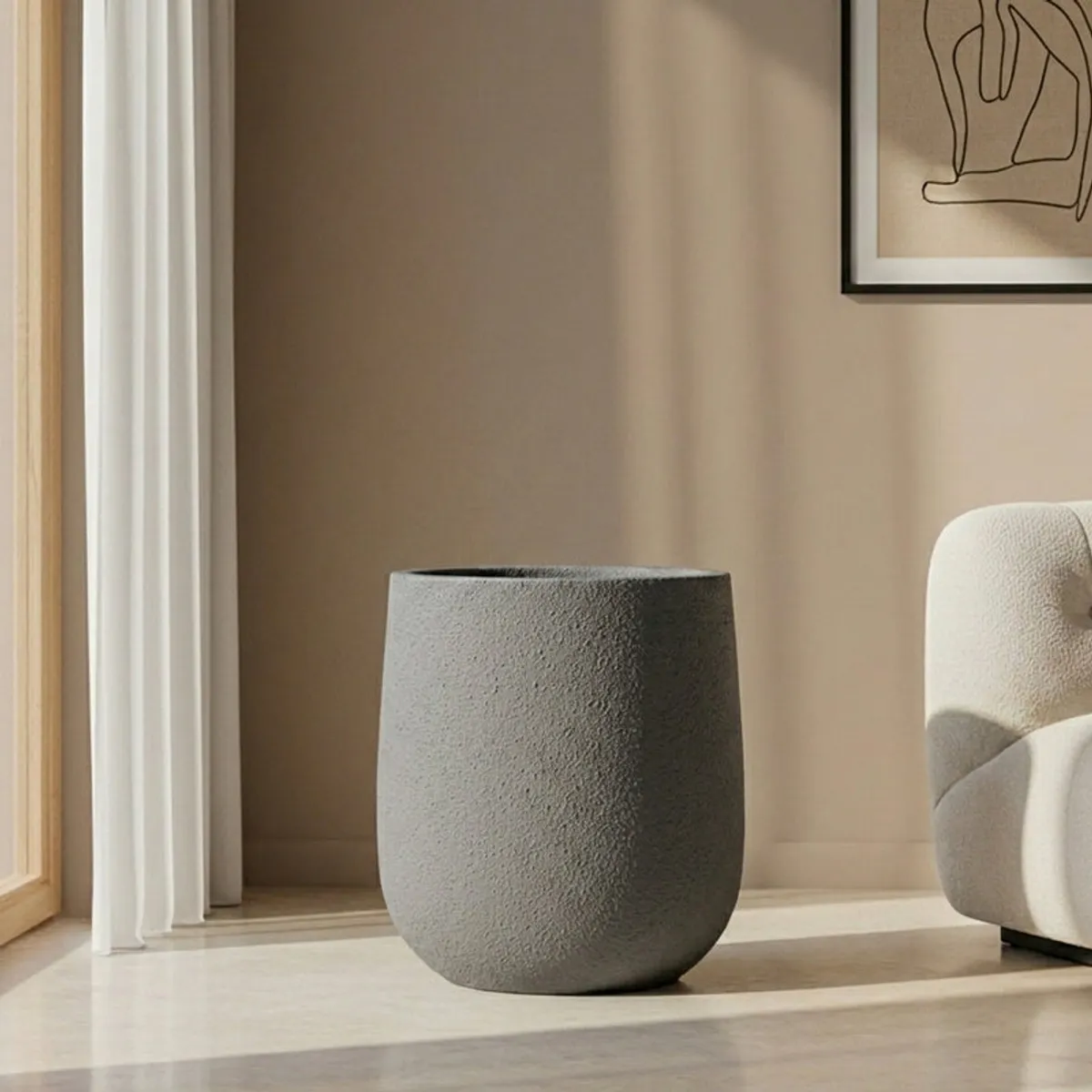 Empty grey cylindrical planter with a rounded base and matte texture
