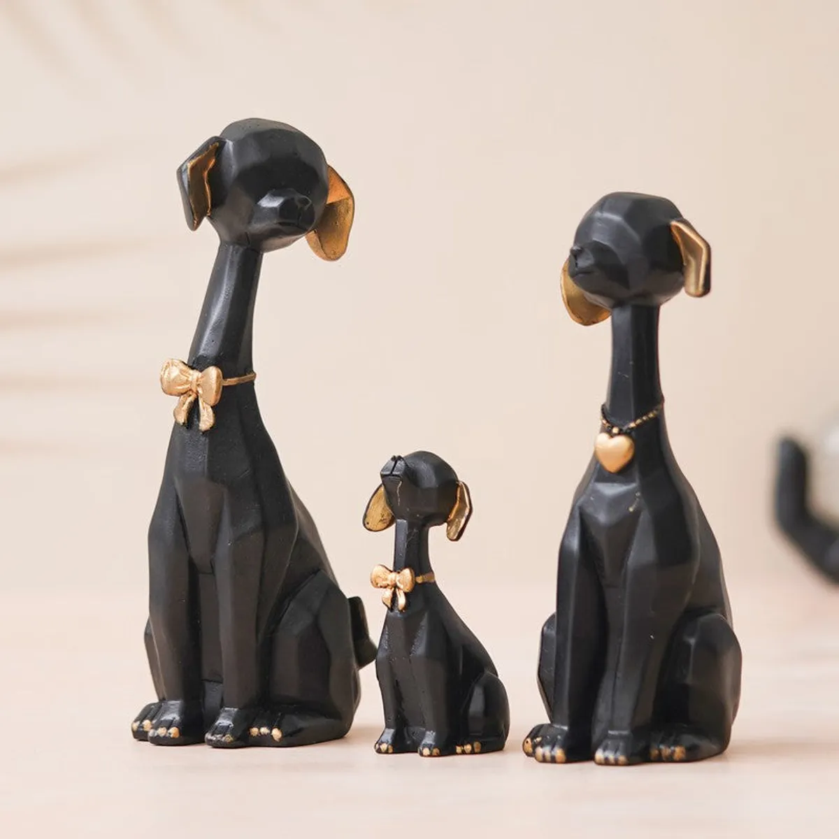 Angled view of black and gold dog showpieces in a set of three