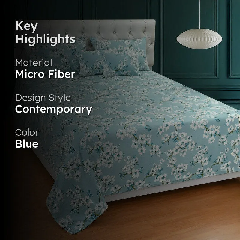 Blue floral bedding set displayed on a bed in a contemporary bedroom