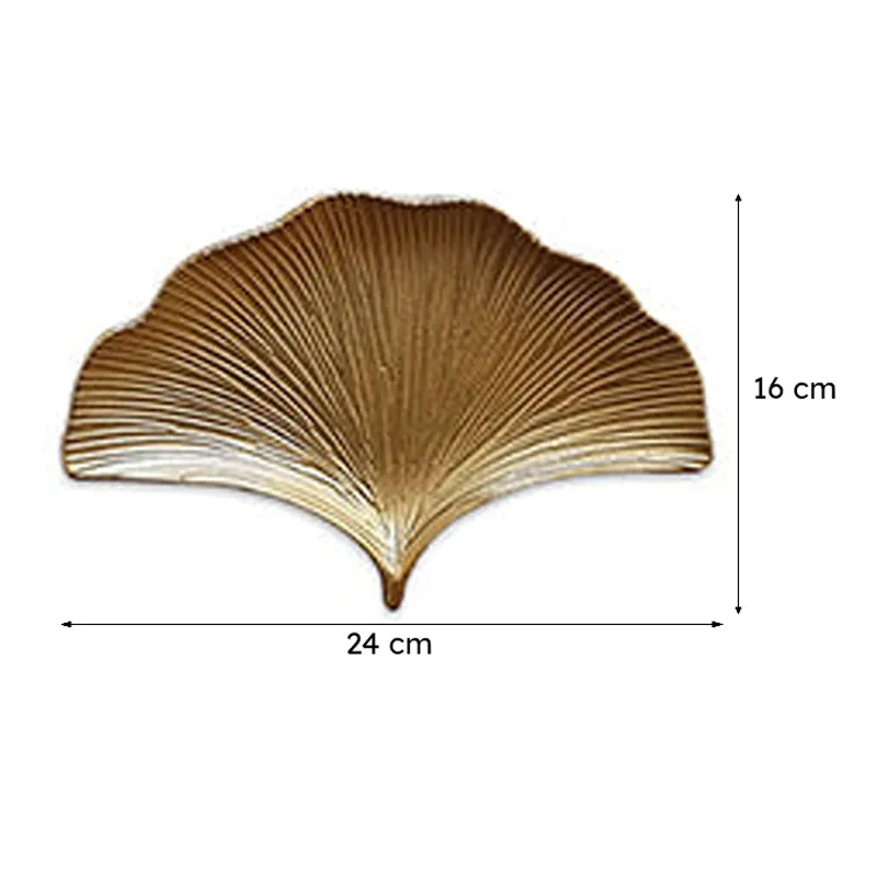 Single gold ginkgo leaf-shaped platter displayed against a white background