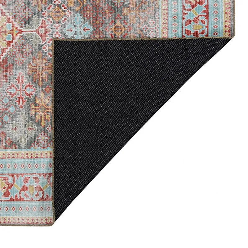 Underside corner of the carpet showing black backing