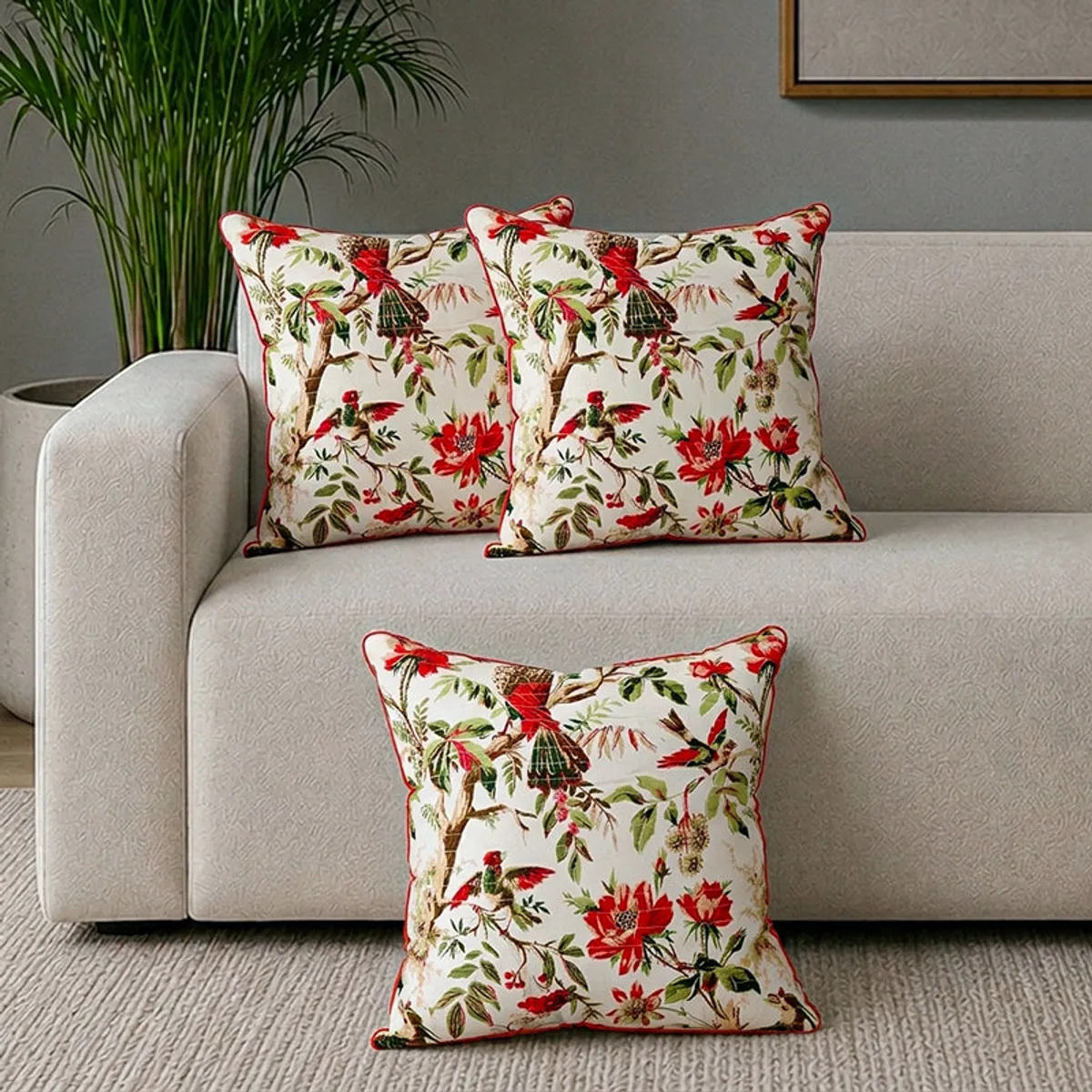 Three matching floral cushion covers arranged on a sofa