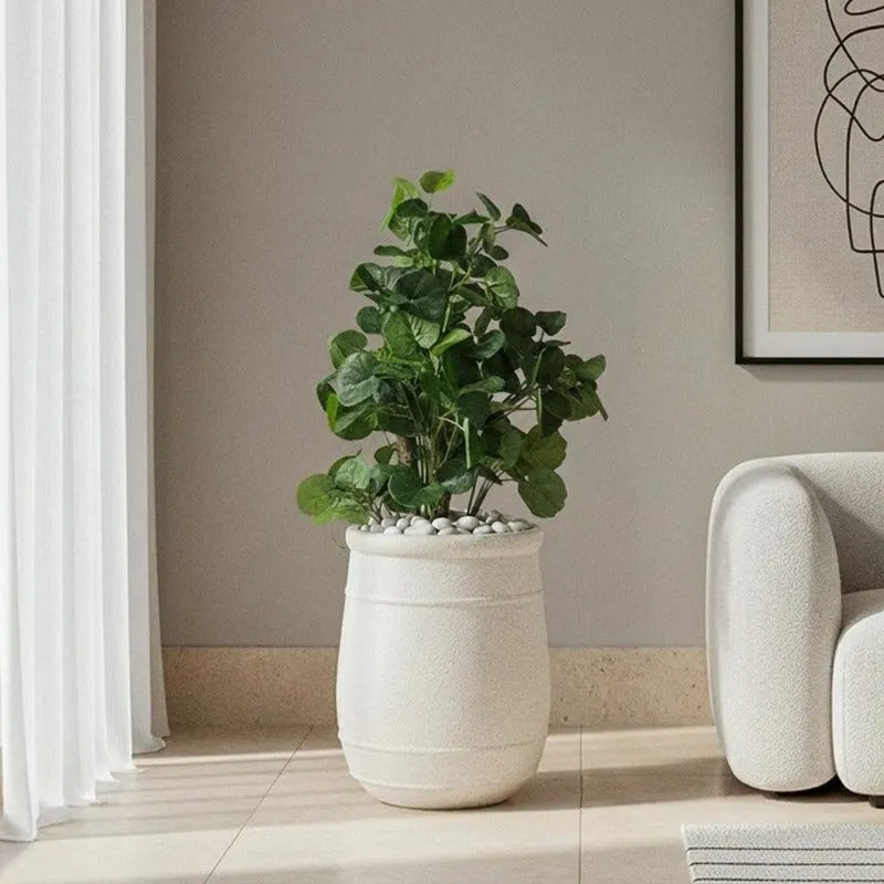 Off-white floor planter styled with a leafy indoor plant in a living room
