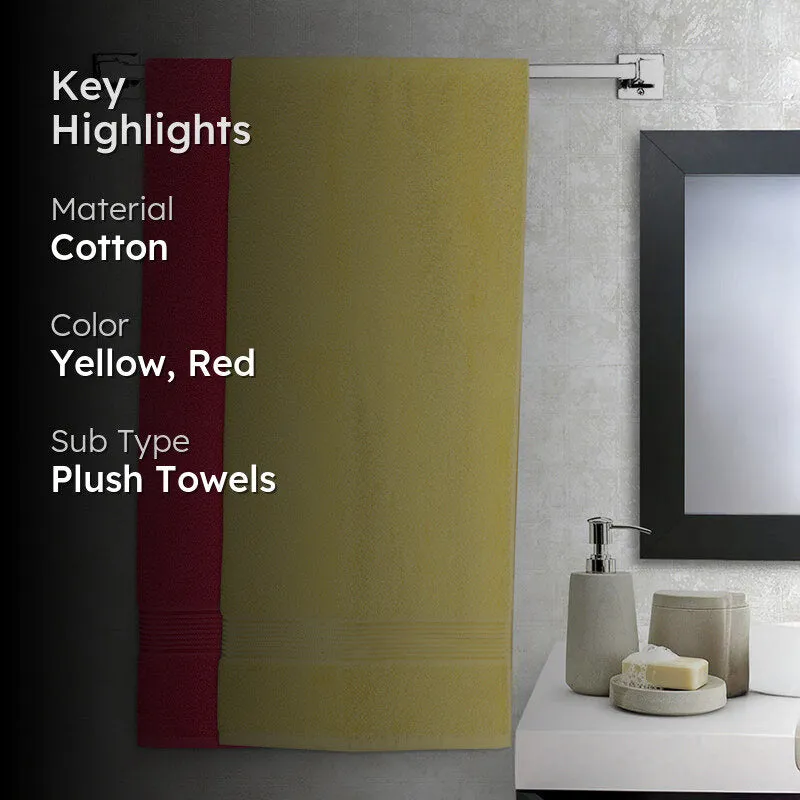 Yellow and red bath towels displayed in a modern bathroom