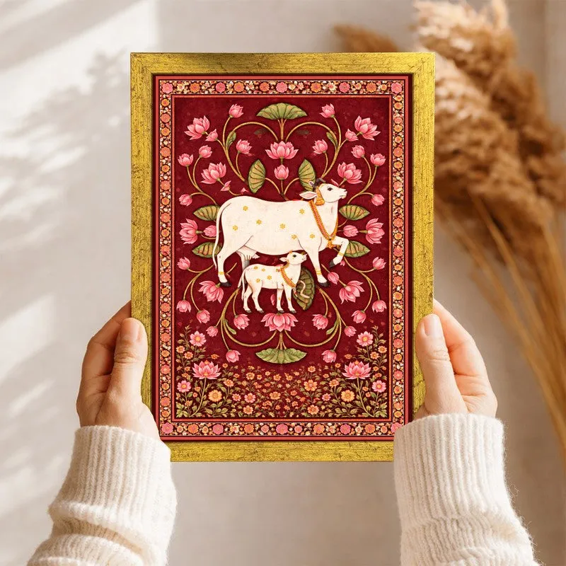 Close-up of a framed crimson artwork showing a white cow and calf with floral detailing
