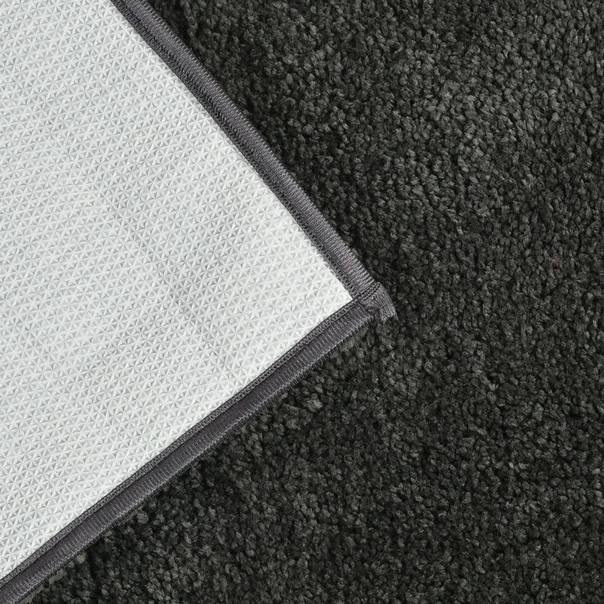 Underside close-up of the bath mat showing textured anti-slip backing