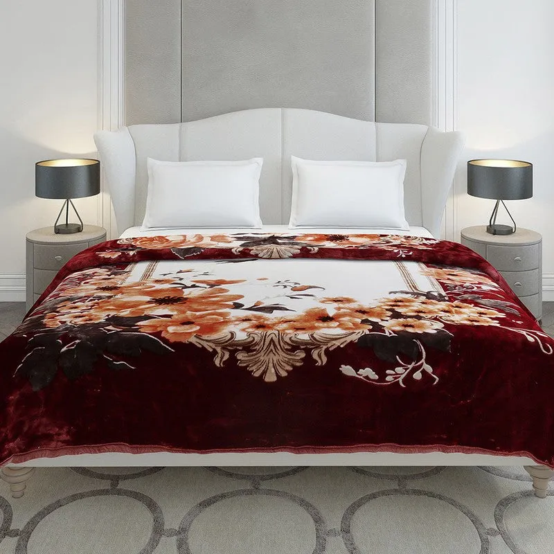 Red and orange floral blanket styled on a double bed