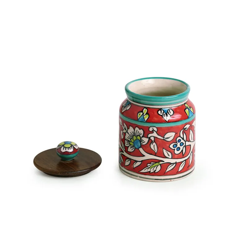 Open floral ceramic jar beside its wooden lid, showing the interior.