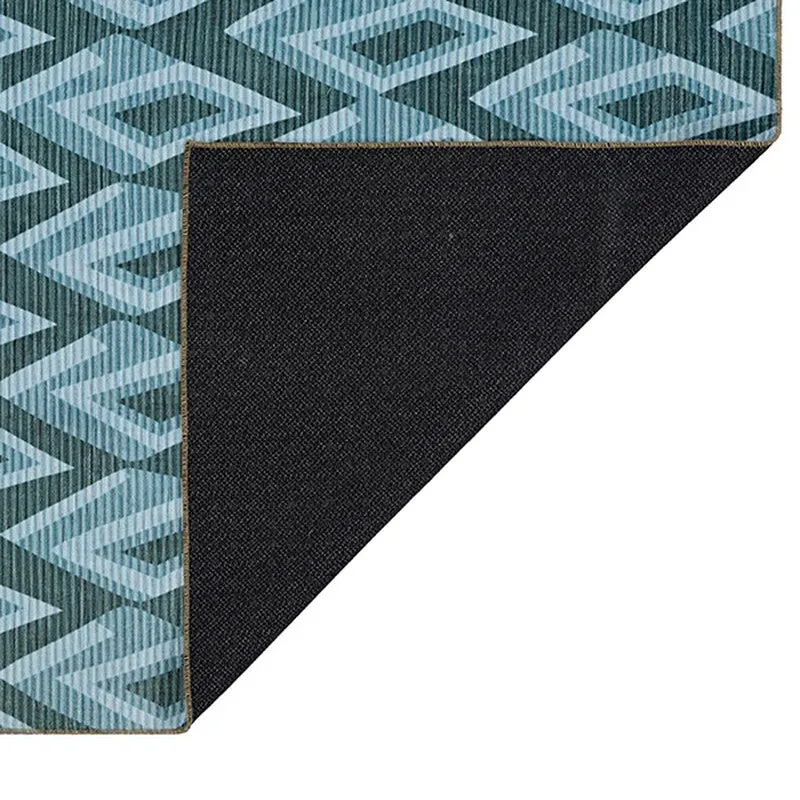 Underside corner of carpet with black backing visible