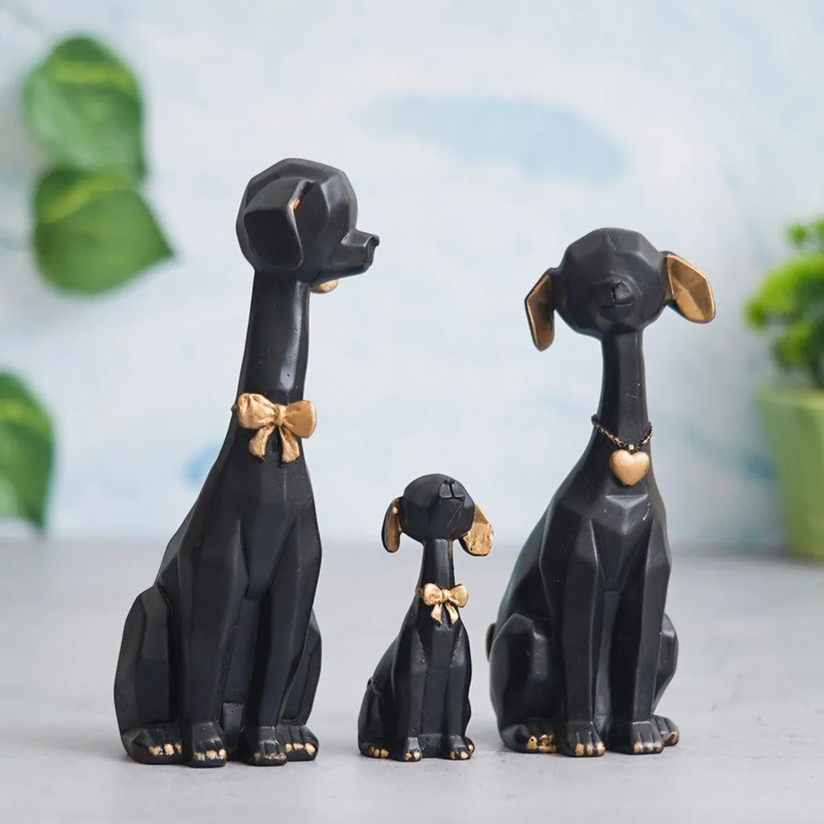 Black and gold dog showpiece trio styled on a tabletop