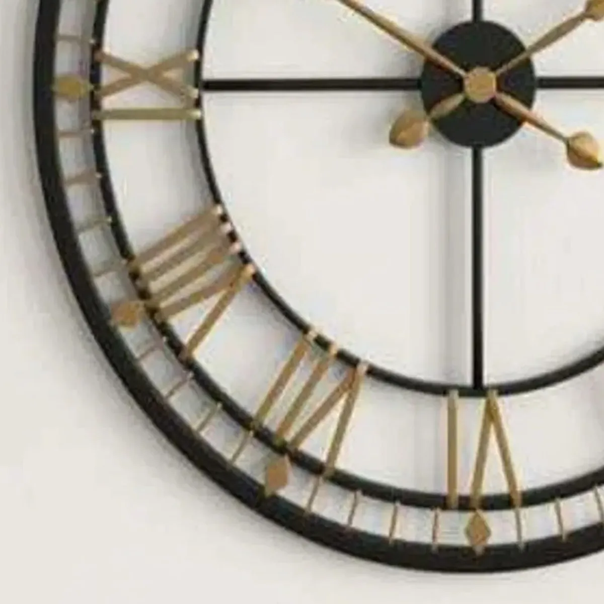 Close-up of the black and gold Roman numeral detailing on the clock