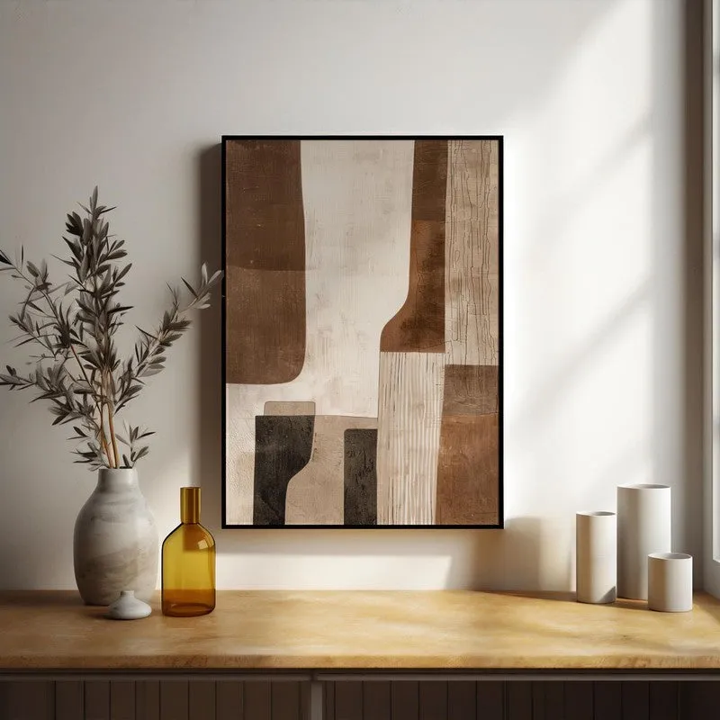 Framed abstract beige painting styled on a console with vases in soft daylight.