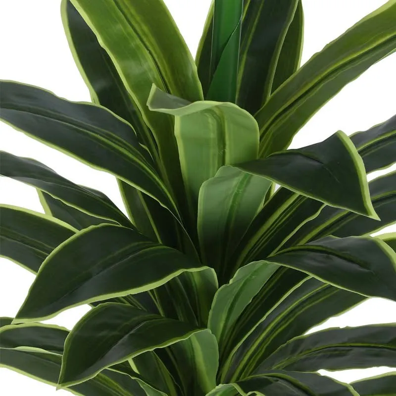 Close-up of the faux plant's layered green leaves