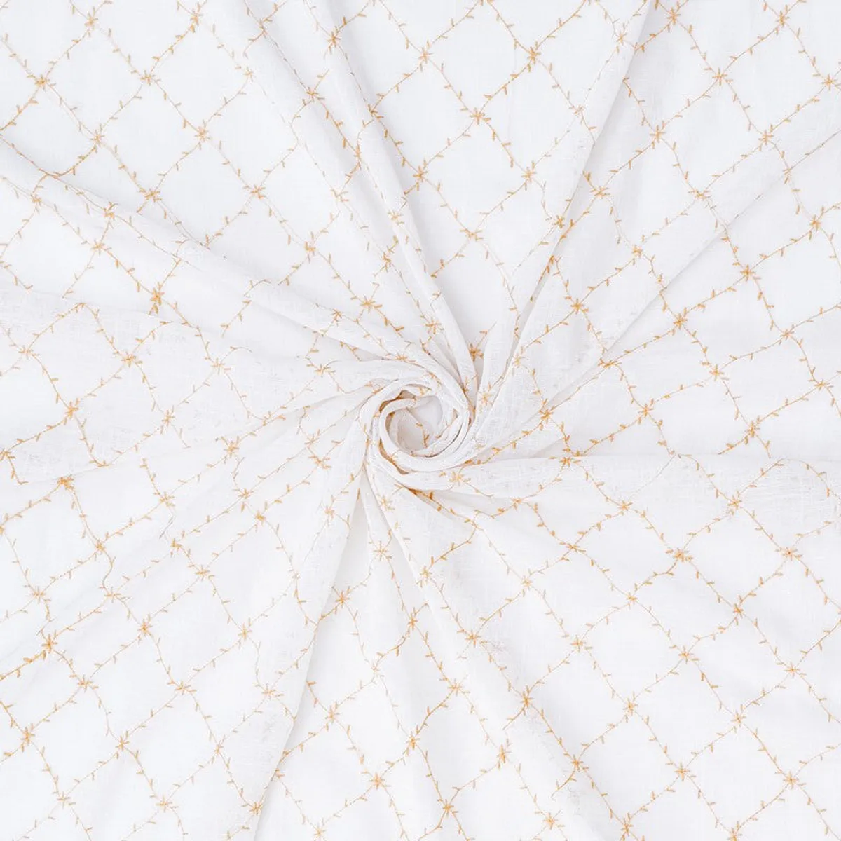 Close-up of white fabric with a repeating gold geometric pattern.