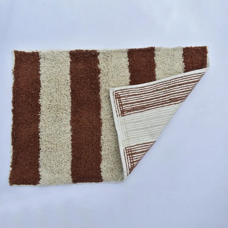 Corner of striped bath mat lifted to show its canvas backing