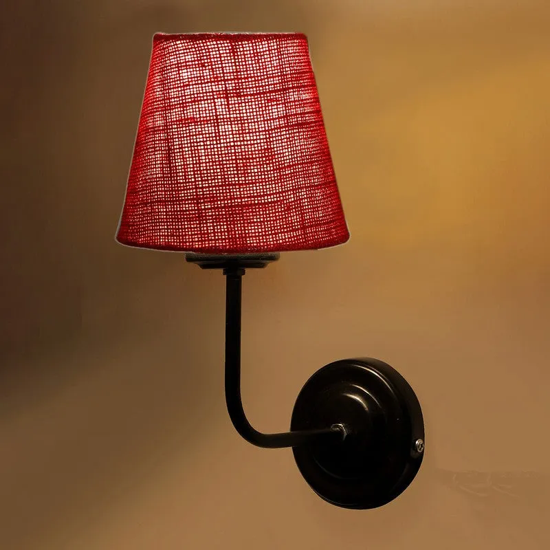 Close-up of red jute shade and black iron wall mount