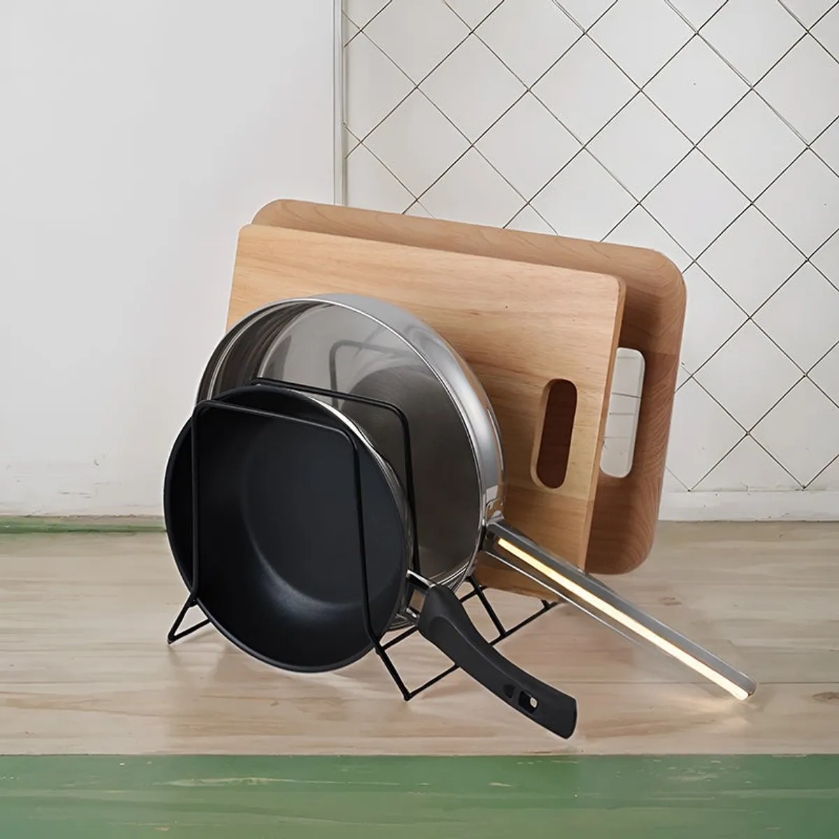 Black metal rack storing pans and wooden cutting boards on a countertop