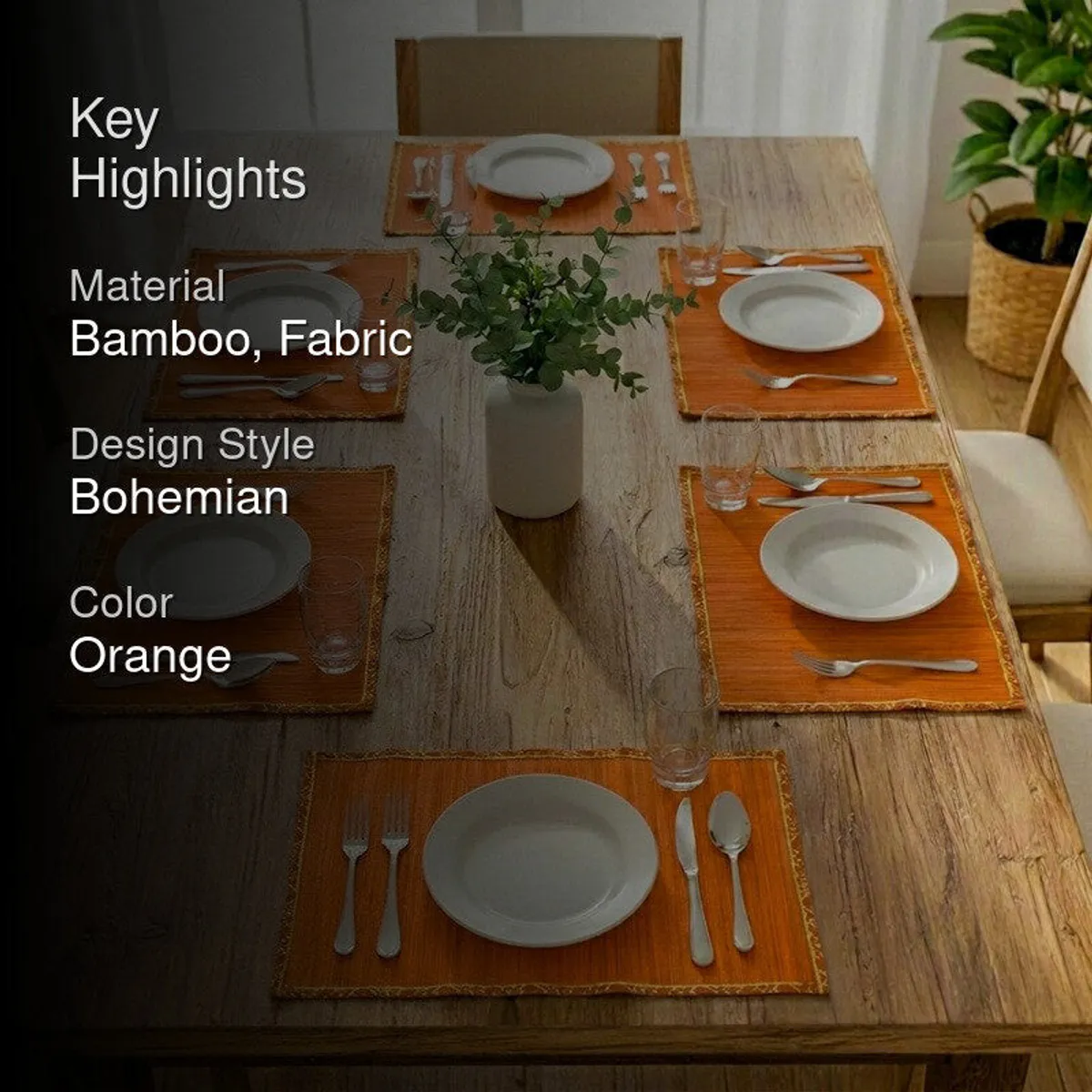 Dining table styled with six orange mats, plates and cutlery