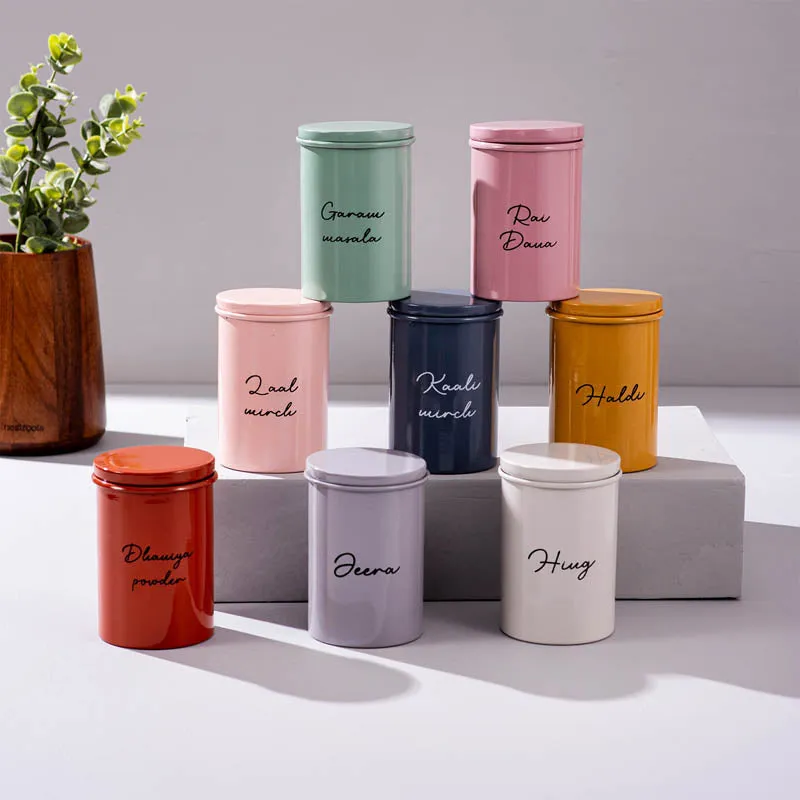 Eight colourful labelled storage jars arranged together on stepped blocks