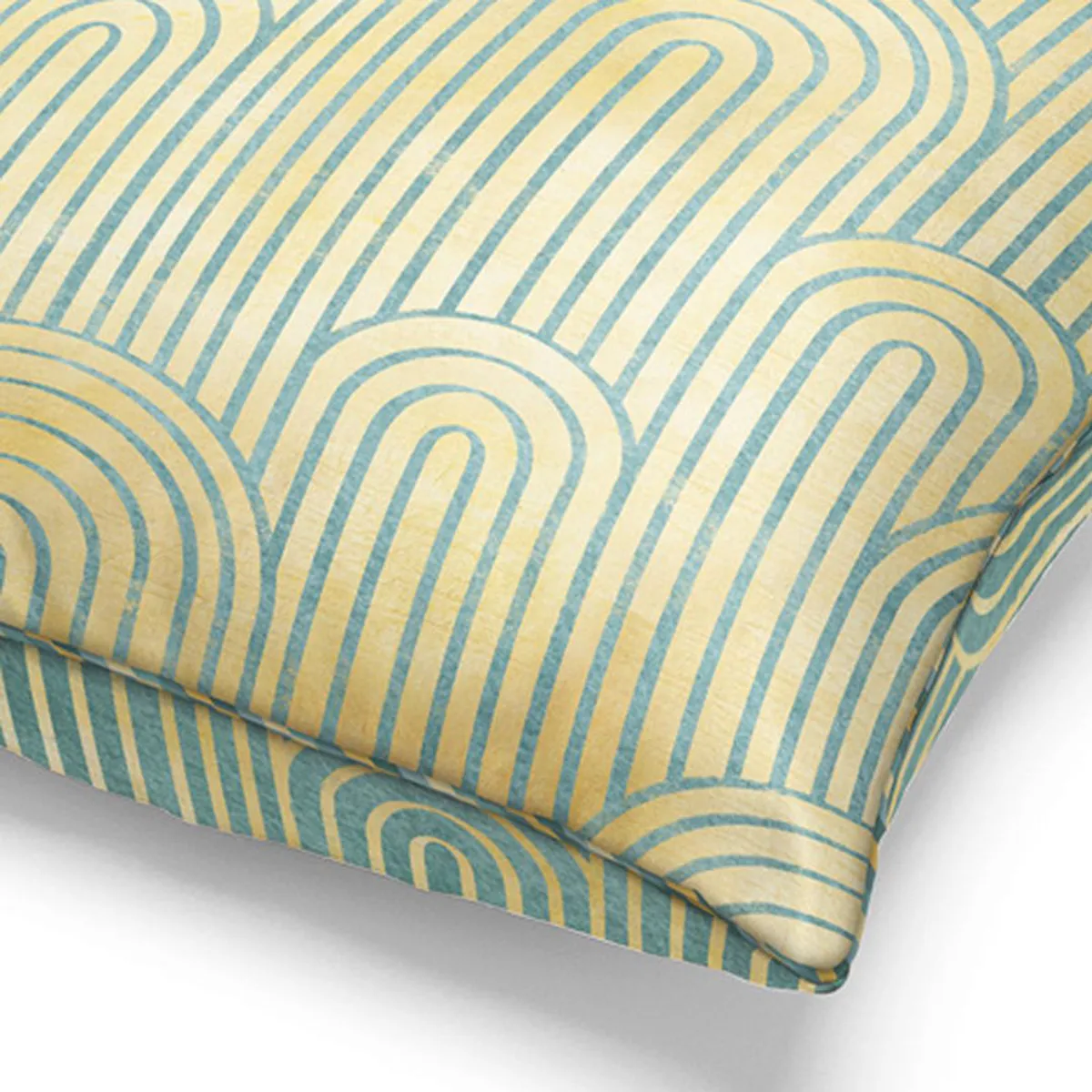 Close-up of the yellow and green geometric arch pattern on the cushion cover