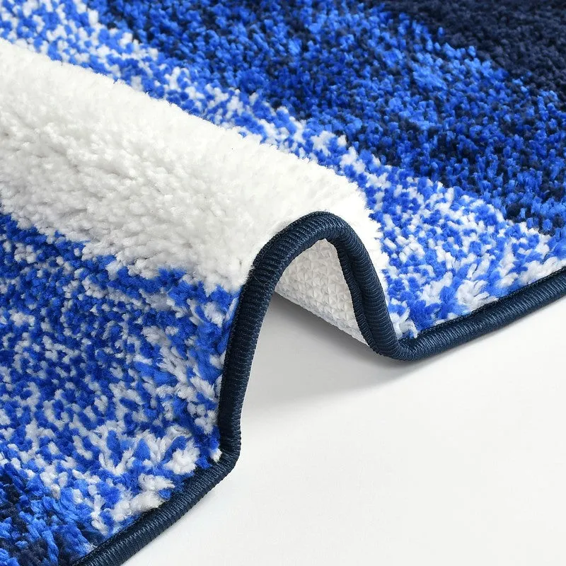 Folded corner of the blue and white bath mat showing thick pile