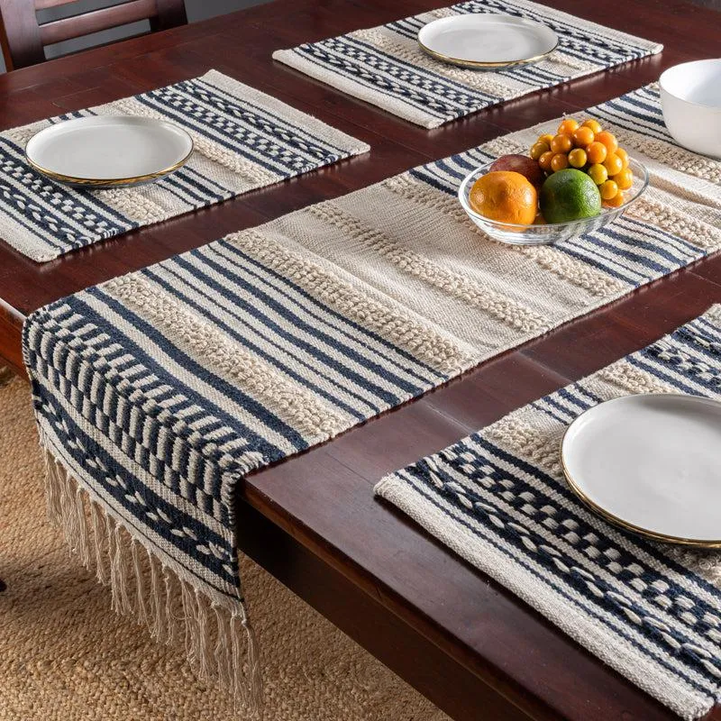 Striped table runner styled across a dark dining table with matching placemats