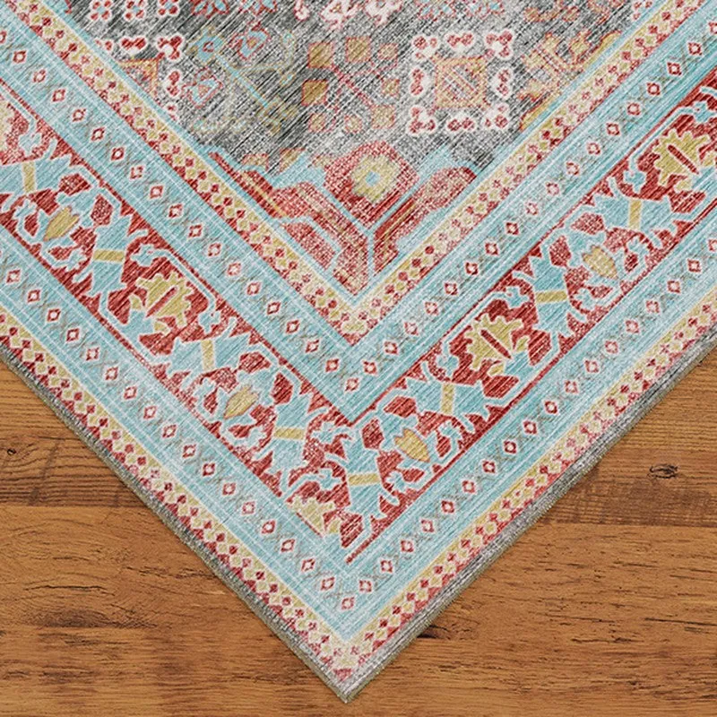 Corner detail of the carpet showing blue border and patterned design