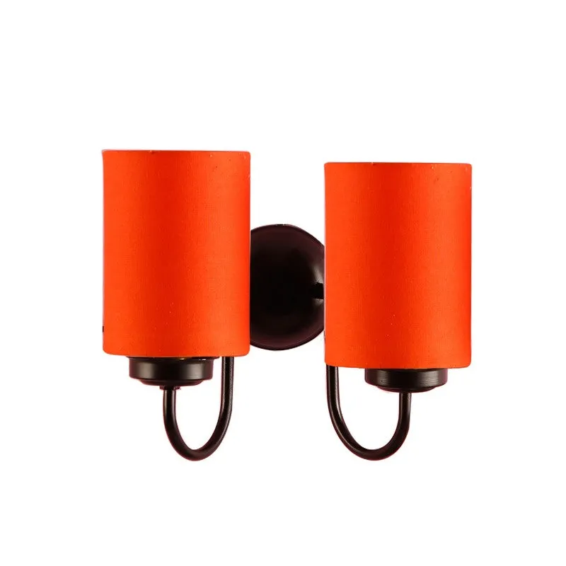 Orange dual wall lamp with black iron mount on a white background