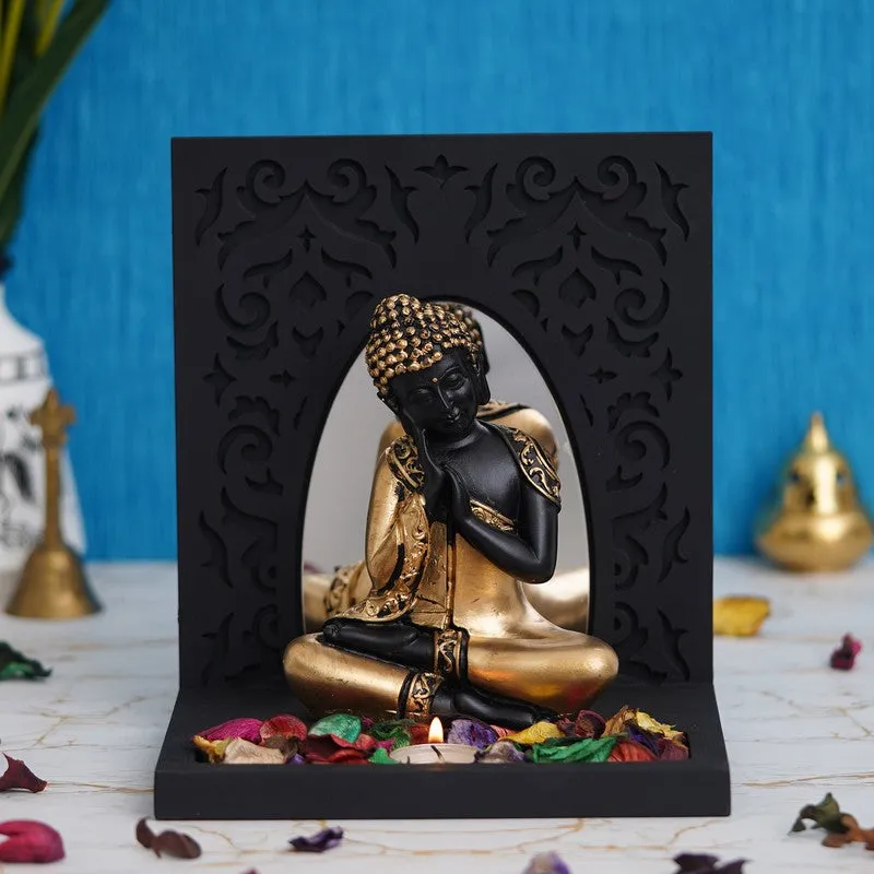 Front view of Buddha tea light candle holder in black and gold finish