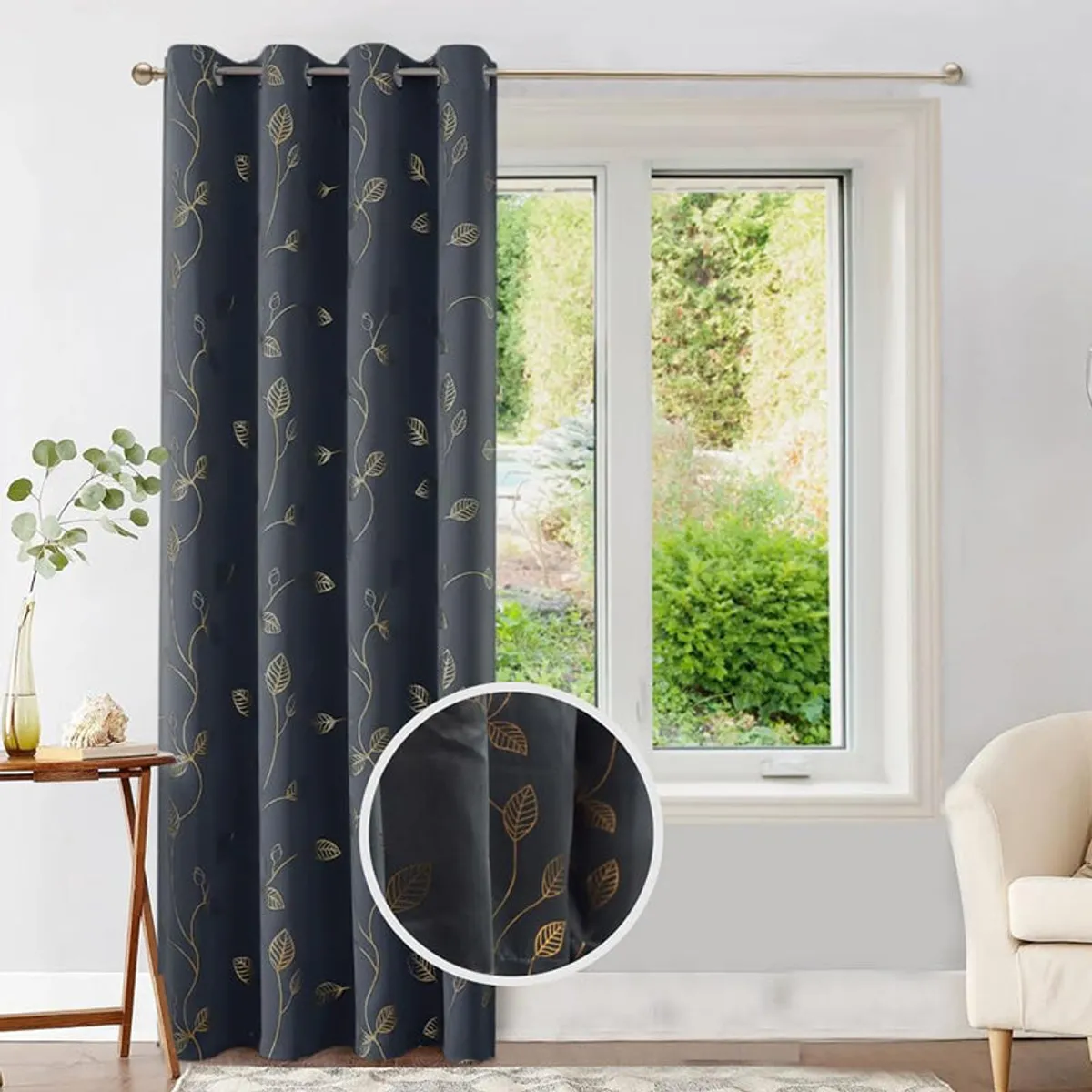 Charcoal curtain with gold leaves shown on a rod beside a window