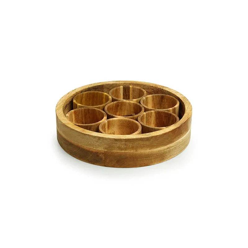 Open round wooden masala box showing seven circular spice containers