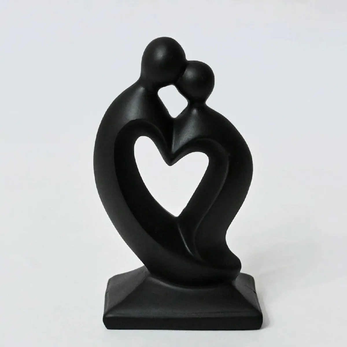 Front view of a black abstract couple showpiece with a heart-shaped centre