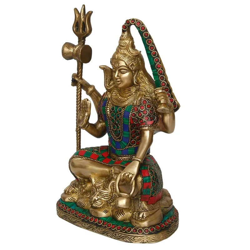 Side view of a seated deity idol with ornate coloured detailing