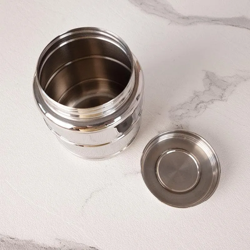 Open glossy silver container and its lid showing the stainless steel interior