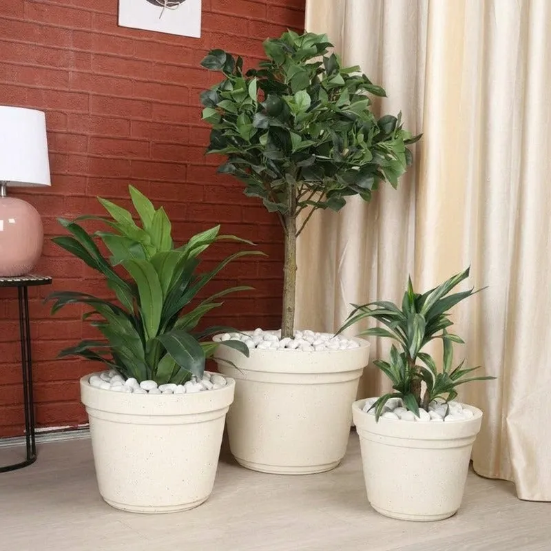 Three off-white planters in different sizes arranged indoors