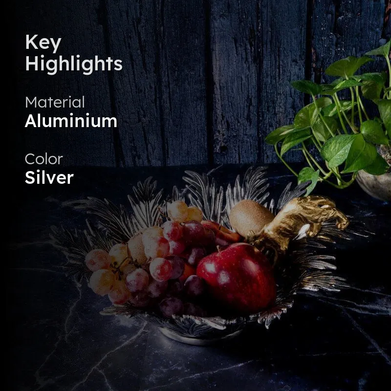 Silver panther accent bowl styled with fruit on a dark surface