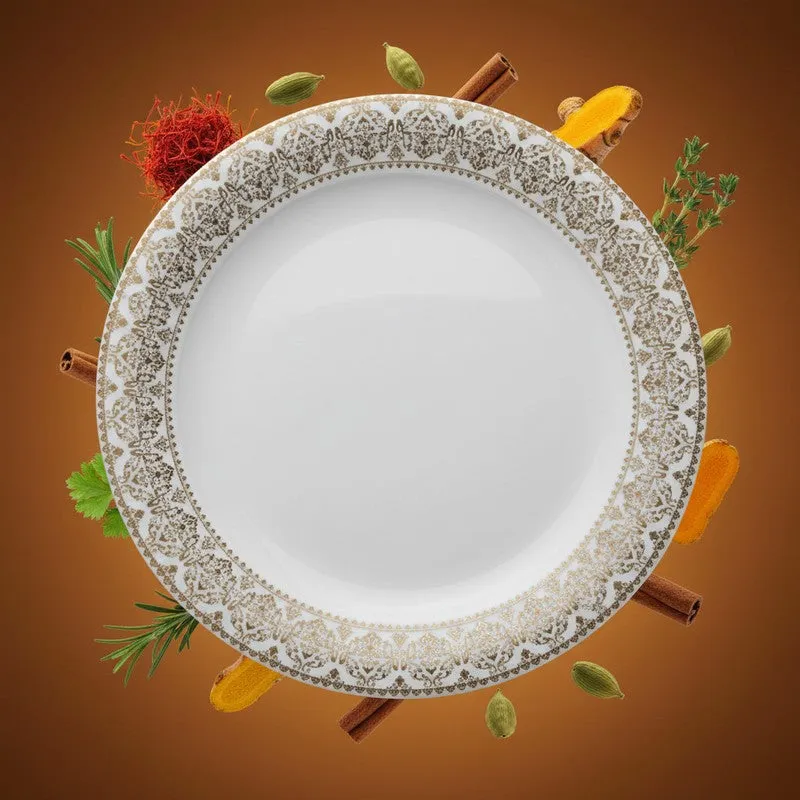 White quarter plate with an ornate gold-toned border, surrounded by cooking spices.