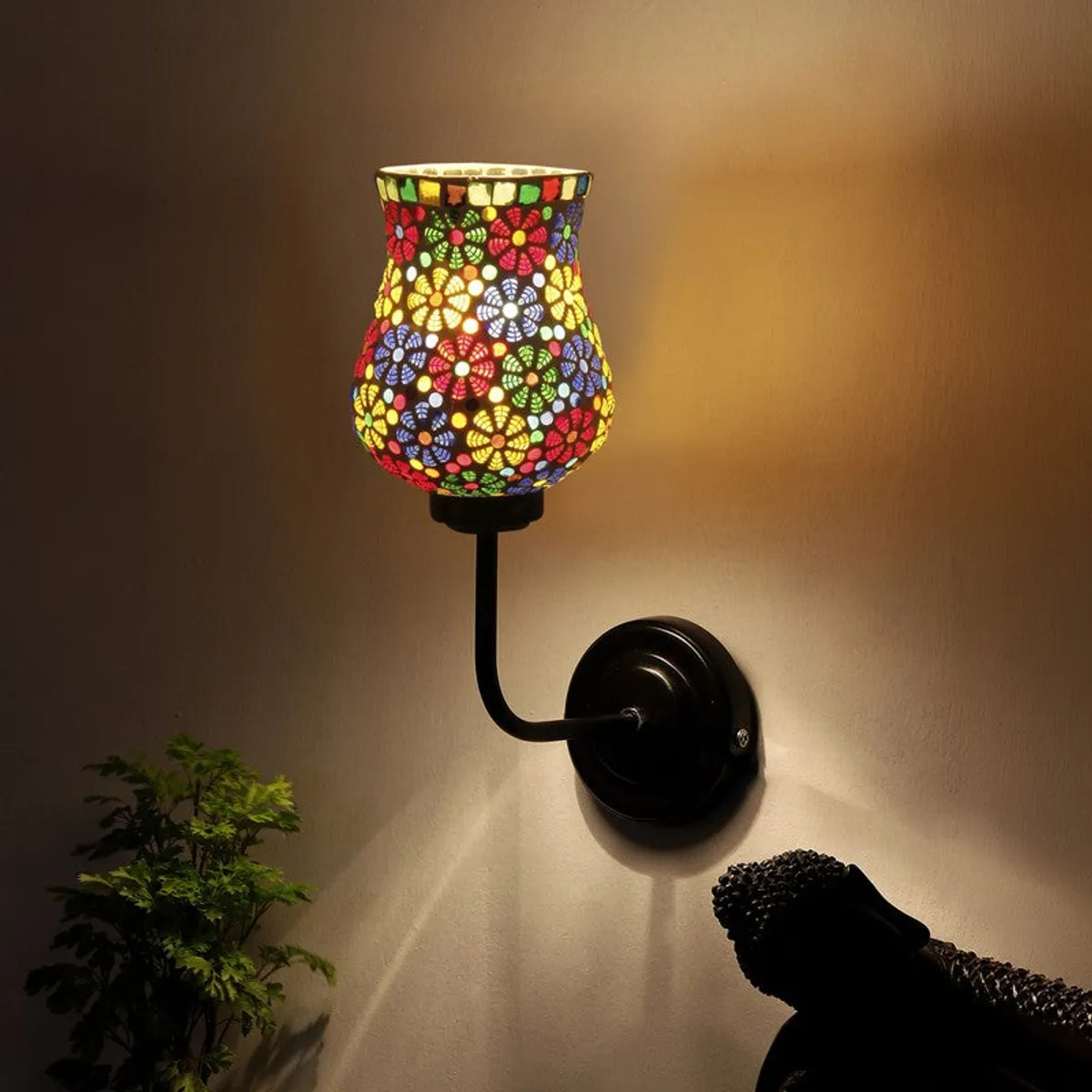 Glowing mosaic glass wall lamp casting warm light on the wall