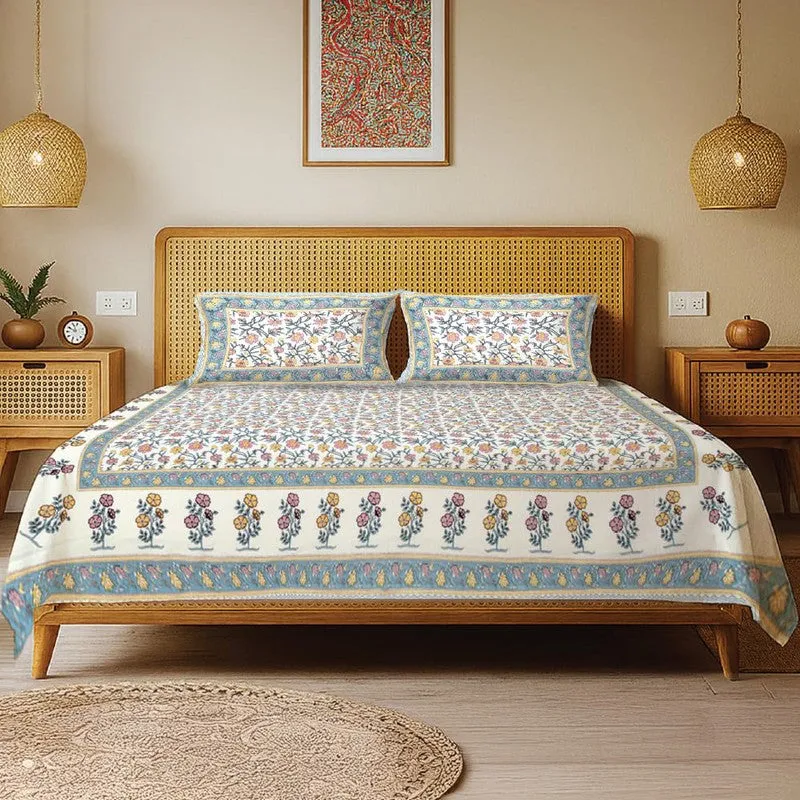 Blue and white floral bedsheet set styled on a cane bed with two matching pillow covers