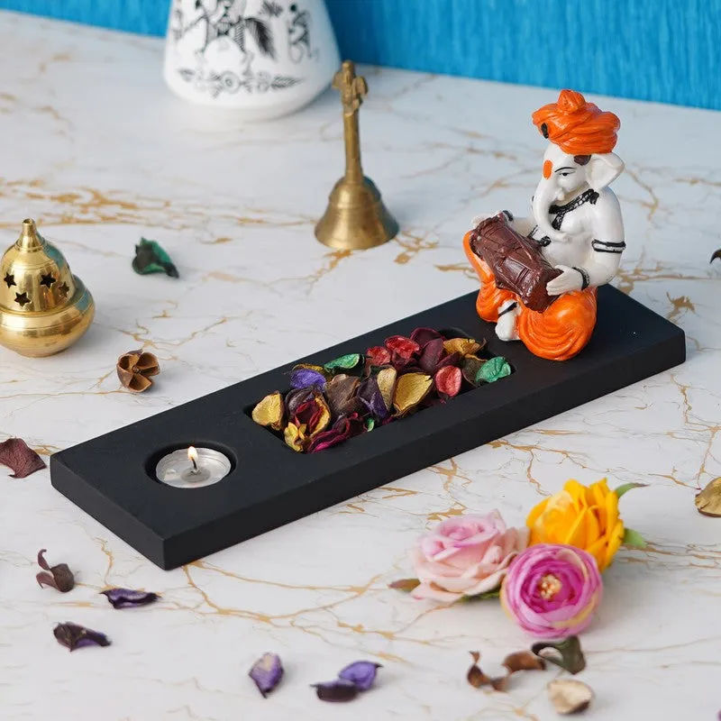 Side view of Ganesha tea light candle holder on a black base