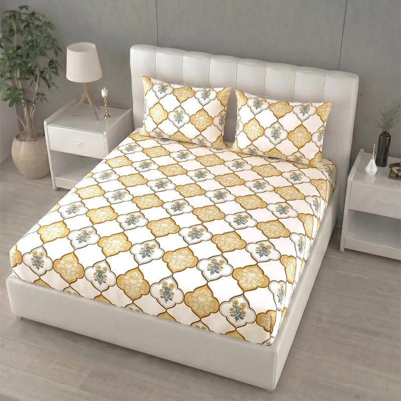 Angled view of printed yellow and off-white bedsheet on upholstered bed