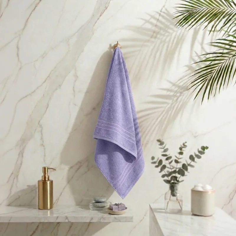 Lavender bath towel hanging in a bright bathroom setting